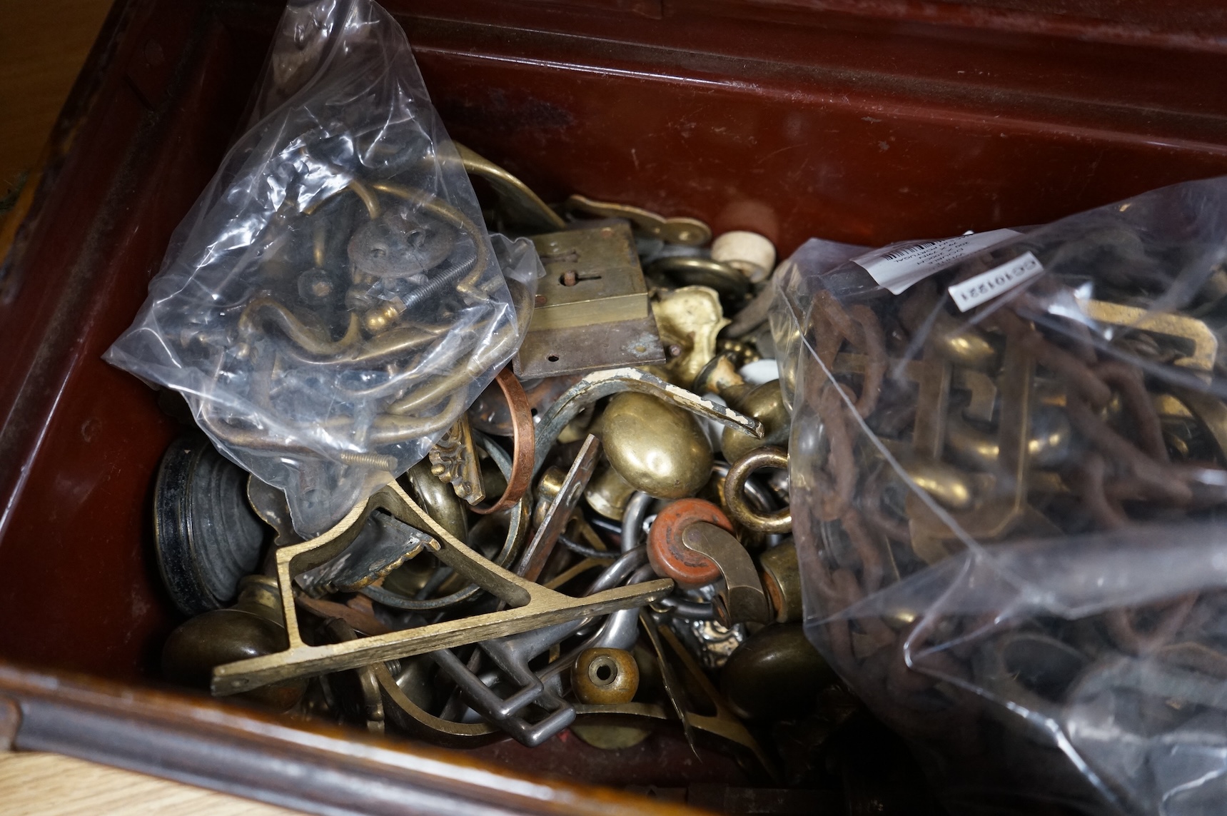 A brush grained tin trunk containing brass furniture mounts and fittings and a micromosaic miniature photo frame and hand mirror, trunk 47cm wide (a.f.)